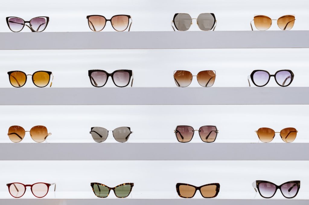 various glasses styles on shelves. Eyeglasses have evolved to become a fashion statement