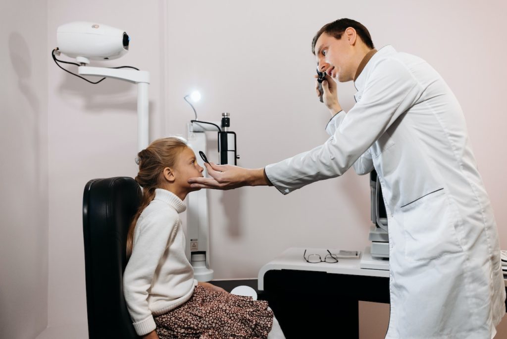 An Ophthalmologists or Optometrists with a patient