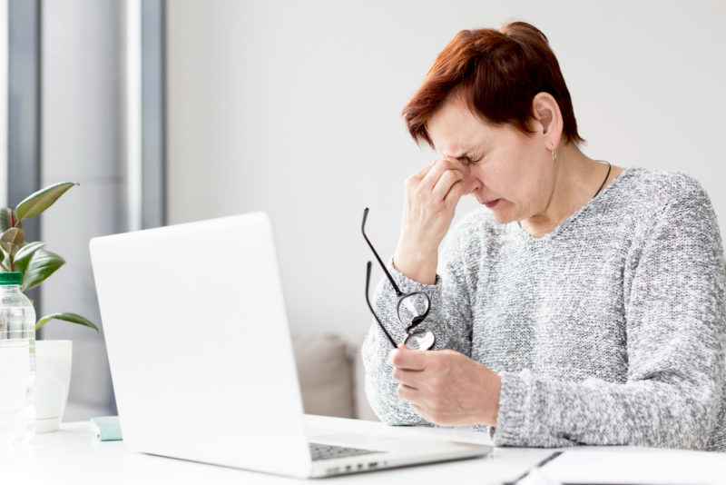 front view woman with anxiety desk. intraocular pressure